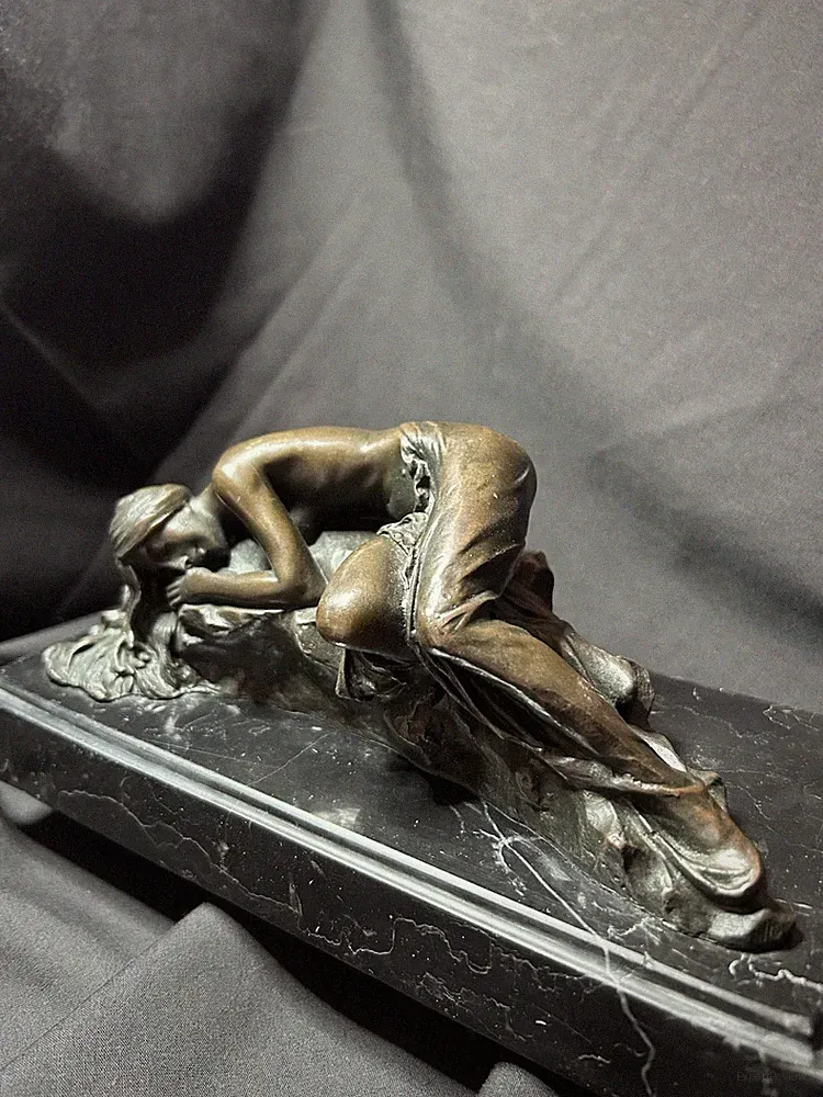 Antique bronze statue of reclining nude female signed “MILO.”